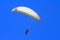 People practicing paragliding in a blue sky VI