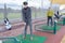 People practise golf at city centre golf driving range