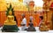 People praying toGolden Buddha statue in Buddhist temple