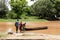 People prepare to cross a rain swollen and flooding river in Africa. Handmade dugout canoe used to transport people and supplies