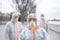 People with protective suits and respirators outdoors, coronavirus concept.