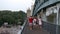 People on Pushkinsky Andreyevsky Bridge over river.