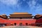 People queuing in front of one of the internal red colored gates of the Palace Museum, known as the Forbidden City, in