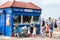 People queuing for ice cream at the seaside