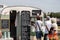 People queuing for tea and coffee at a vintage caravan converted into a mobile cafe