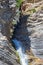 People rappelling in an impressive waterfall