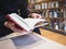 People reading book open page bookshelf in library