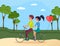 People in relationship riding bicycle with balloon. Couple on tandem on road in forest or park
