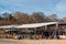 People relax in a coastal cafe on a sunny winter day. View of the outdoor cafe on the sea beach in winter