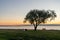 People relax in a coastal park in Tallinn at sunset and enjoy a summer evening