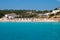 People relax on public beach of Cala Romantica