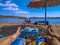 People relax on a sandy beach in the bay of the Red Sea Sharm El Sheikh, Egypt. Female and male legs on sunbeds against the