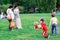 People relax in summer park. Kids plaing with soap bubbles