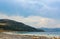 People relax on the white shore of the azure lake