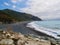 People relaxing at the black pebble beach in Nonza, Cap Corse, Corsica.