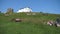 People relaxing on the Castle hill in Tenby