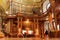 People relaxing inside the Austrian National Library with old luxury furniture