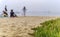 People relaxing on the Pacific Ocean beach Half Moon Bay by San Francisco, empty due to the covid-19 pandemic, foggy day