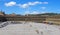 People relaxing on the steps and cafes and walking across the square of halifax piece hall in west yorkshire in summer sunshine