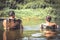 People relaxing during their leisure camping holidays on river and looking on beautiful scenery