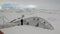 People on research expedition vessel in ice icebergs of Antarctica Ocean.