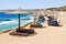 People rest on beach of Siva Sharm ex Savita Resort 5 * hotel in Sharks Bay, Sharm El Sheikh, Egypt. Warning red flag on beach