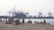 People resting on the beach near to the cargo port in Gdansk