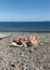 People are resting on a sunny day at the beach in Machico. Madeira Island