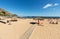 People are resting on a sunny day at the beach in Machico. Madeira Island