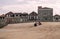 People resting and talking near Casa da MÃºsica with the old historic houses of Av. da Boavista on background