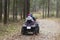 People ride an ATV in the autumn forest.Motor vehicles