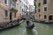 People ride gondolas along the canals of Venice