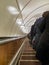 People ride a long escalator in the subway