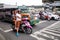 People ride scooters on street in Manila, Philippines