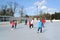 People ride a skating rink. Central park of rest