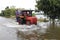 People ride their vehicles through the flooded roads