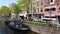 People riding bikes along the canal in Amsterdam