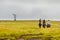 People riding horses towards a flat hill at Easter Island, Chile