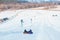 people riding snow tubing at winter park