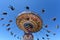 People riding on spinning swing carousel in amusement park