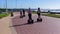 People Riding Stand Up Scooters Beach Ocean