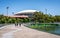 People on riverbank curved footbridge over torrens river and Adelaide Oval stadium in background in Adelaide SA Australia