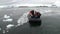 People rubber boatt in ice on water surface of Antarctica Ocean.