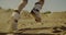 People running uphill with sandboards in hands in the desert. Sport, tourism, lifestyle, commercial, advertisement