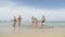 People Running From Water On Beach, Young Man And Woman Group Happy Tourists