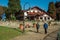 People and rustic house on a park in Gramado