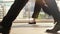 People`s feet walk on pedestrian crossing on a busy day in the center of the city on a sunny day on the road on the