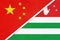 People`s Republic of China or PRC vs Abkhazia national flag from textile. Relationship between two asian countries