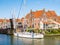 People on sailboat and open drawbridge to old harbour of Enkhuizen, Noord-Holland, Netherlands