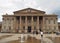 people in saint georges square huddersfield in front of the facade of the historic victorian train station